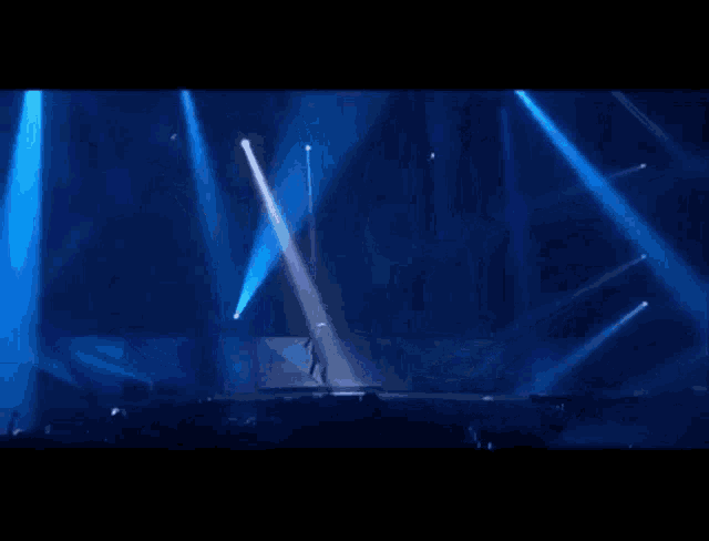 the word alive is on a stage in front of a crowd