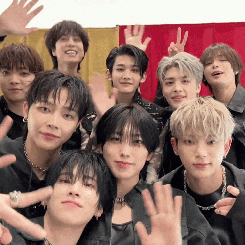 a group of young men are posing for a picture and one of them is wearing a necklace