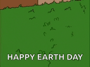 homer simpson from the simpsons is standing in the grass .