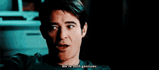 a woman says " we 're both geniuses " in front of a door