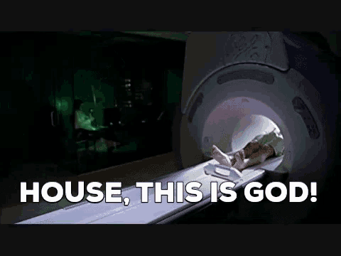 a man in a lab coat is talking on a phone and the words house , this is god are projected on the wall behind him