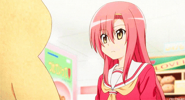 a girl with pink hair stands in front of a sign that says " love "