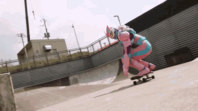 a person in a pink and blue outfit is riding a skateboard