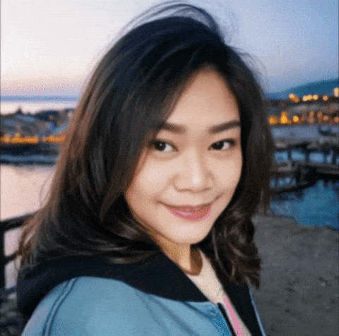 a woman in a blue jacket is smiling for the camera