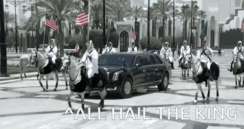 a group of men riding horses in front of a limousine that says all hail the king on the bottom