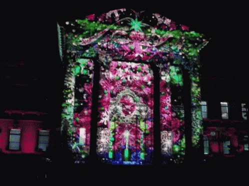 a building with a floral design projected on the side of it