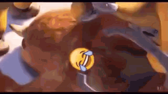 a close up of a cartoon character with a laughing emoji on it 's face .