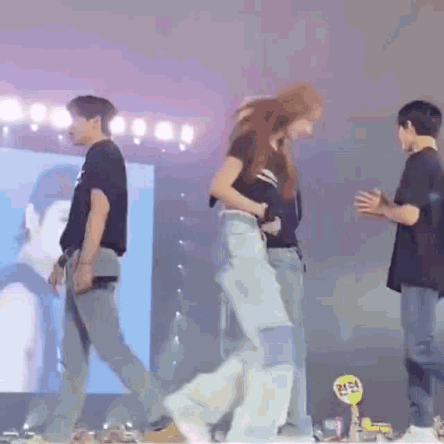 a man and a woman are dancing on a stage .