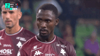 a soccer player wearing a maroon shirt with mosl on it