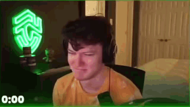 a man wearing headphones is sitting in front of a computer .