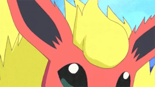 a close up of a cartoon eevee with a yellow tail and a red head .