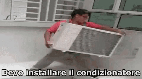 a man is carrying an air conditioner with the words devo installare il condizionatore written below him