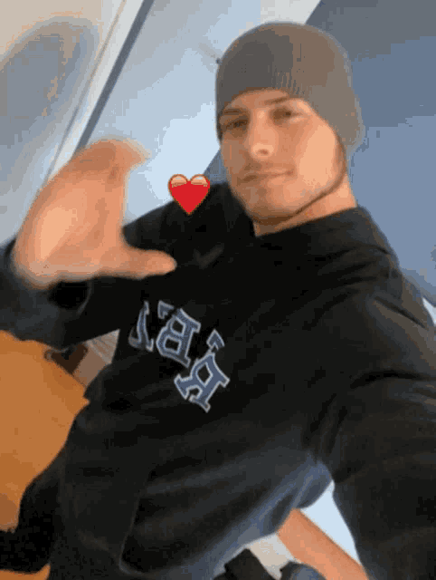 a man wearing a beanie and a hoodie that says ' nba ' on it
