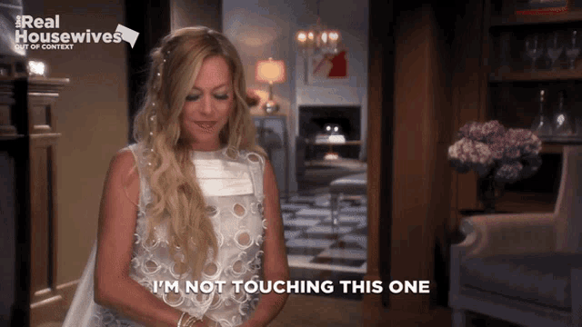 a woman says i 'm not touching this one in front of a real housewives logo