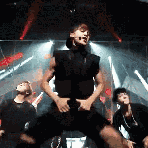a group of young men are performing on a stage .