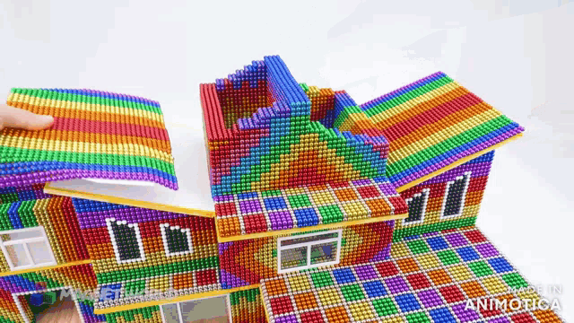 a colorful house made of magnets with the words made in animatica on the bottom right