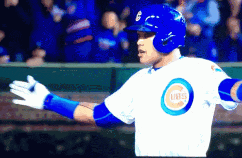 a baseball player wearing a white jersey with a cubs logo