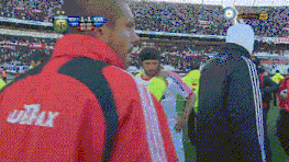a man wearing a red jacket that says ultrax on the back