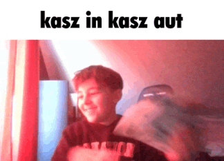 a young boy is holding a stack of money and smiling with the words kasz in kasz aut below him .