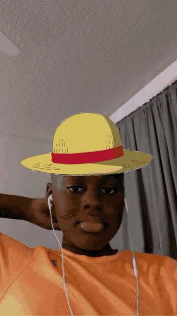 a man wearing a yellow hat with a red ribbon