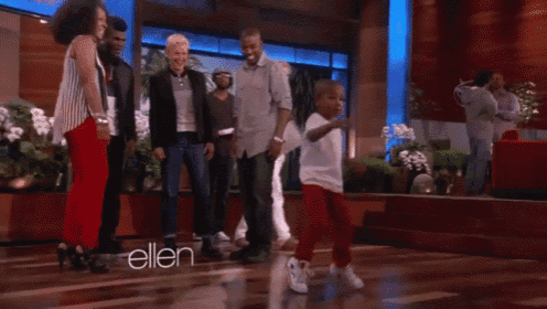 a group of people are dancing on a stage with the name ellen on the bottom