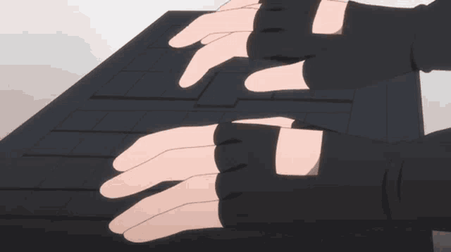 a person wearing black gloves is using a keyboard
