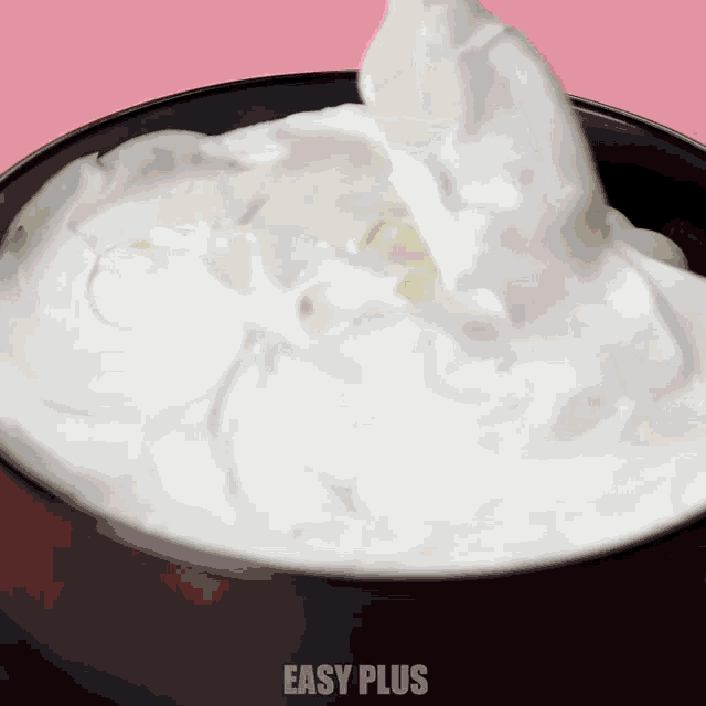 a bowl of whipped cream has easy plus written on the bottom of it