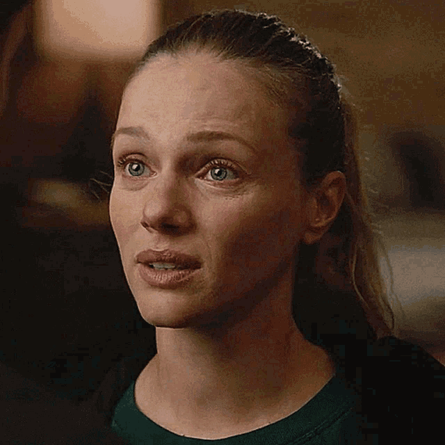 a close up of a woman 's face with a tear running down her cheek