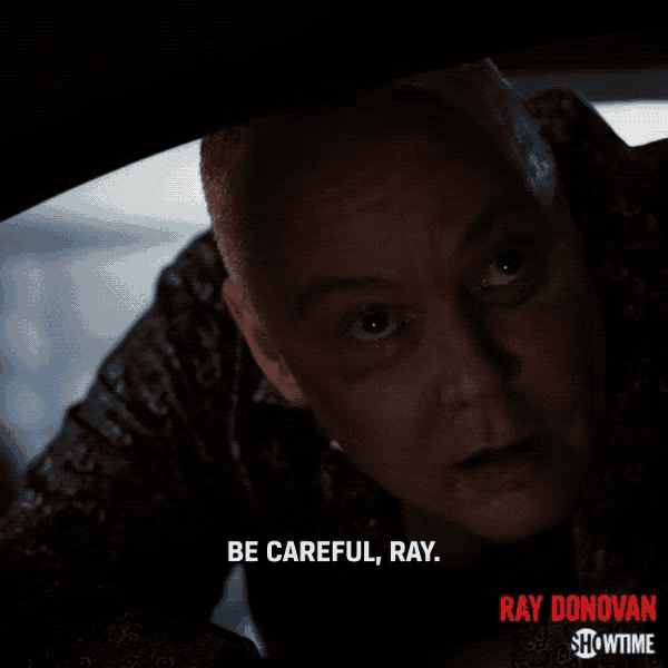 a poster for ray donovan showtime shows a man in a dark room