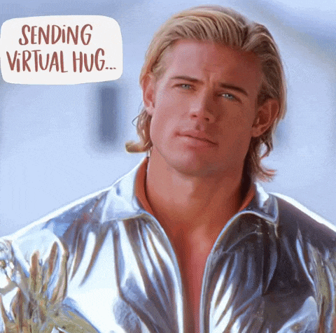a man in a silver jacket with the words sending virtual hug behind him