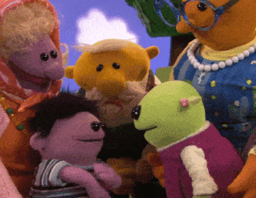 a group of stuffed animals are standing next to each other and one of them has glasses on