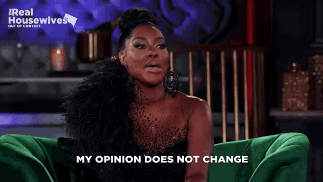 a woman sitting on a green couch with the words my opinion does not change