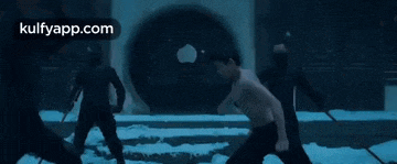 a group of men are fighting each other in the snow .