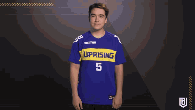 a young man wearing a blue uprising jersey