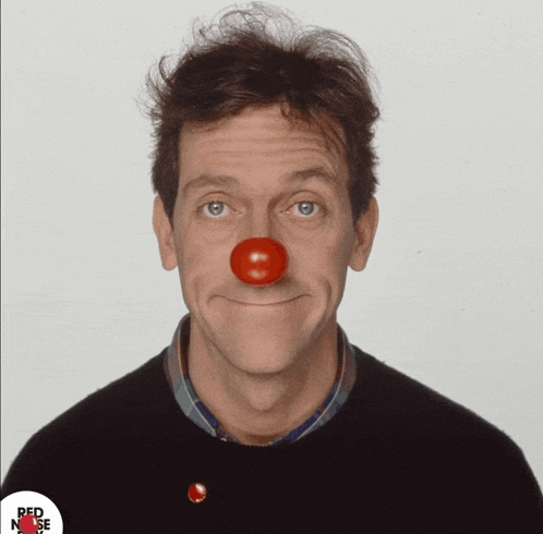 a man with a red nose has a red nose button on his shirt