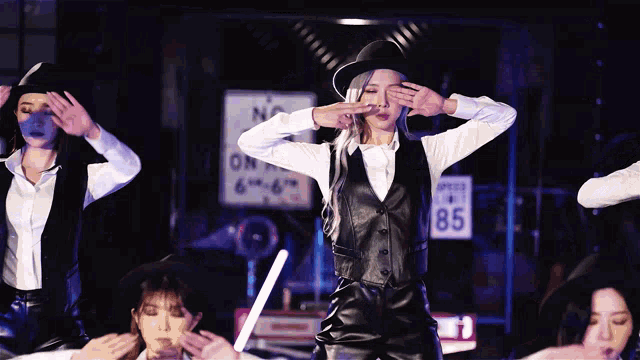 a group of women dancing in front of a sign that says speed 85