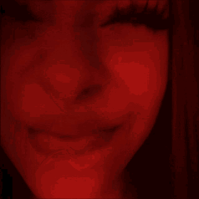 a close up of a woman 's face with a nose ring