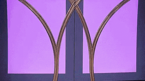 a purple background with a purple border and a gold sculpture