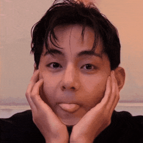 a young man is sticking his tongue out while making a funny face