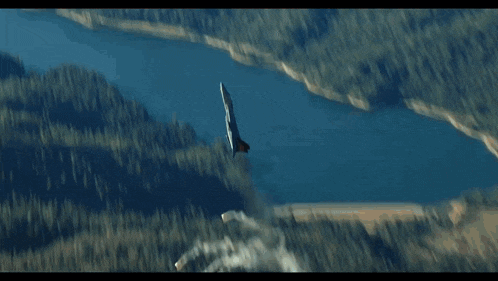 a jet is flying through the air with smoke coming out of it