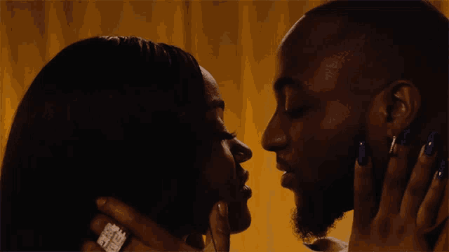 a man and a woman are kissing and the man has a diamond ring on