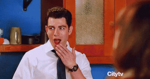 a man in a white shirt and tie is covering his mouth with his hand while a woman looks on ..