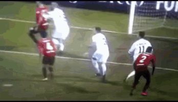 a soccer player with the number 2 on his jersey is being tackled by another player