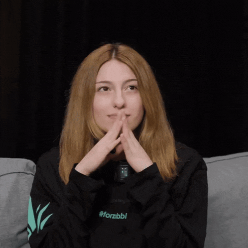 a woman wearing a black sweatshirt with #forzbbl on the sleeve