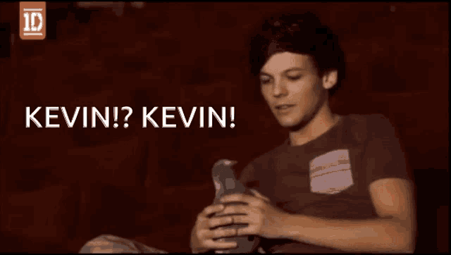 a man sitting in a theatre with the words " kevin kevin " written above him