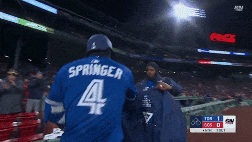 a man in a blue jays jacket is being chased by another man