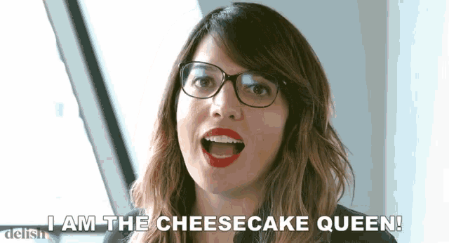 a woman wearing glasses and red lipstick says " i am the cheesecake queen "