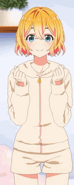 a girl with yellow hair and blue eyes is wearing shorts and a hoodie