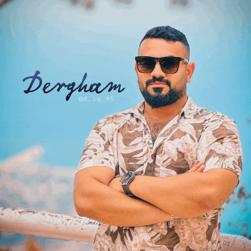 a man wearing sunglasses stands with his arms crossed in front of a sign that says bergham
