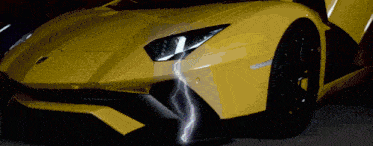 a close up of a yellow sports car with a lightning bolt coming out of the headlight